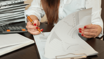 Womans-hands-working-through-paperwork