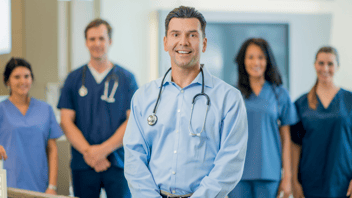 Male-dentist-standing-with-team