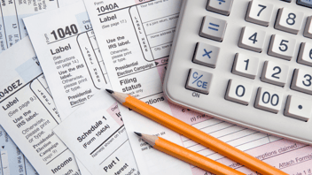 Tax-forms-underneath-calculator-and-yellow-pencils